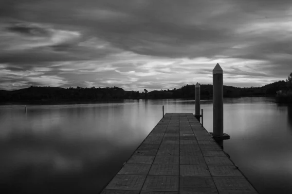 Greyscale Pier Sea Surrounded Islands Covered Greenery Cloudy Sky — 스톡 사진