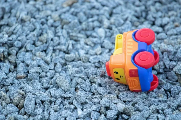 Closeup Plastic Toy Car Ground Covered Small Rocks Sunlight — Stock Photo, Image