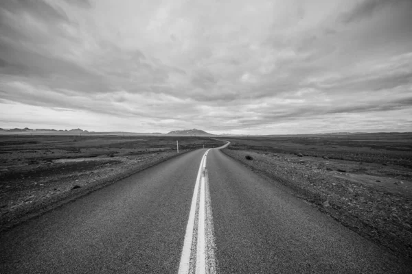 Grayscale Shot Road Middle Field Cloudy Sky — Stock Photo, Image