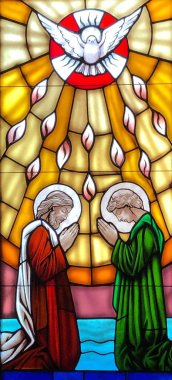 OCEAN SPRINGS, UNITED STATES - Nov 11, 2018: Stained glass image of the Pentecost taken at St. Elizabeth Seton Church clipart