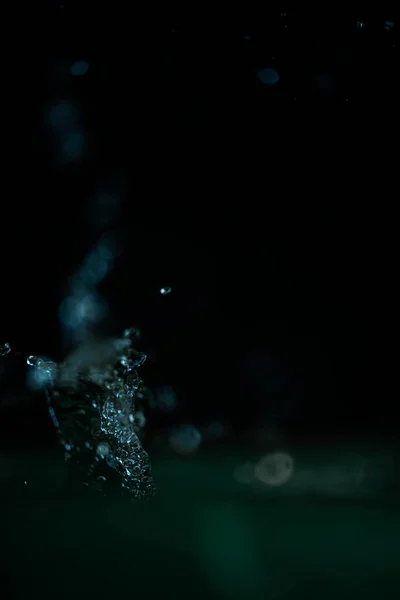 Eine Vertikale Aufnahme Eines Blauen Wasserspritzers Bewegung Auf Schwarzem Hintergrund — Stockfoto
