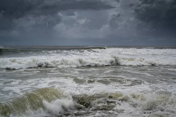 Фотографія Великих Хвиль Вздовж Сонячного Узбережжя Під Темним Хмарним Небом — стокове фото