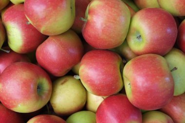 A high angle shot of delicious fresh apples in the market clipart