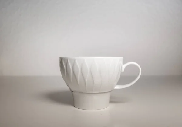 A wide angle shot of a white mug in a white background