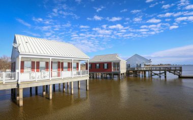 MANDEVILLE, LOUISIANA, UNITED STATES - Feb 06, 2018: Fontainebleau State Park, Louisiana - February 2018: Rental cabins perched over Lake Pontchartrain inside Fontainebleau State Park. clipart
