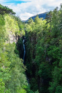An vertical aerial shot of Corrieshalloch Gorge between steep and rocky walls clipart