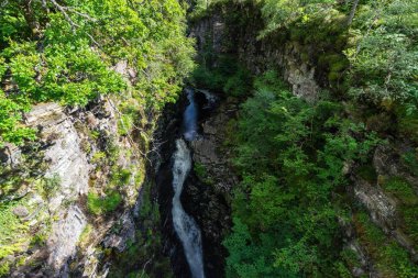 An aerial shot of Corrieshalloch Gorge between steep and rocky walls clipart