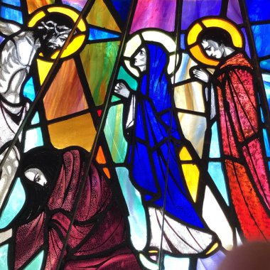 OCEAN SPRINGS, UNITED STATES - Aug 07, 2018: Stained Glass image of Jesus speaking to Virgin Mary and St. John. Taken at St. Alphonse Catholic Church. clipart