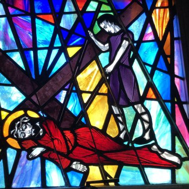 OCEAN SPRINGS, UNITED STATES - Aug 07, 2018: Stained Glass image of Jesus falling for the third time. Taken at St. Alphonse Roman Catholic Church. clipart