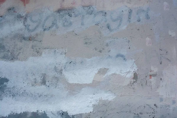 Closeup Shot Concrete Wall Faded Writing Covered Layers Paint — Stock Photo, Image