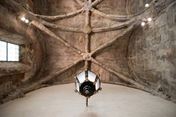 A low angle view of a lamp and the ceiling of The Convent of Our Lady of Mount Carmel in Lisbon