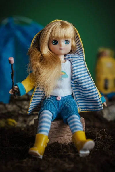 Vertical Closeup Shot Blond Doll Sitting Toy Hiking Camp — Stock Photo, Image