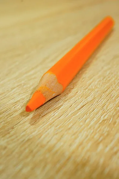 Een Verticaal Shot Van Een Oranje Tekenpotlood Een Houten Ondergrond — Stockfoto