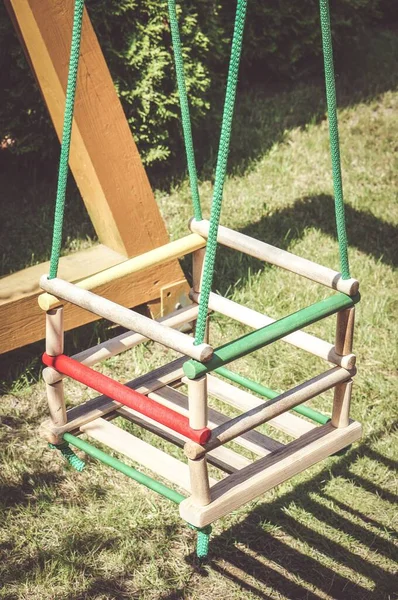 Vertical High Angle Closeup Shot Small Children Swing Grassy Ground — Stock Photo, Image