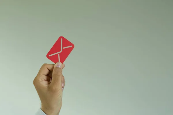 Man Holding Red Message Icon Beige Background — Stock Photo, Image