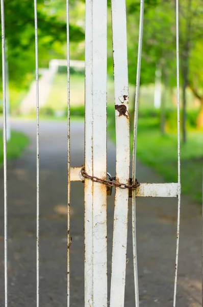 公園の錆びた白い門の垂直ショット — ストック写真