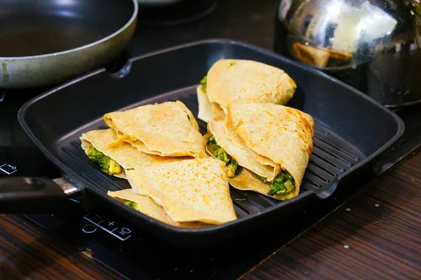 Special food with flatbread and vegetables on a black pan