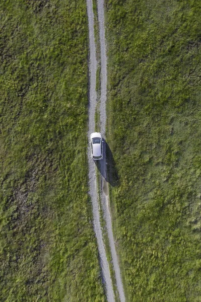 Вертикальний Високий Кут Пострілу Білого Автомобіля Їде Шляху Зеленій Долині — стокове фото