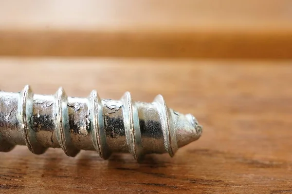 Closeup Shot Pointed End Silver Screw Wooden Table — Stock Photo, Image