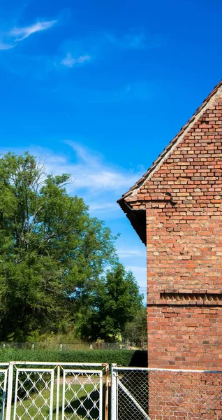 Vertical Shot Building Made Red Bricks Blue Sky Trees Background — Stock Photo, Image