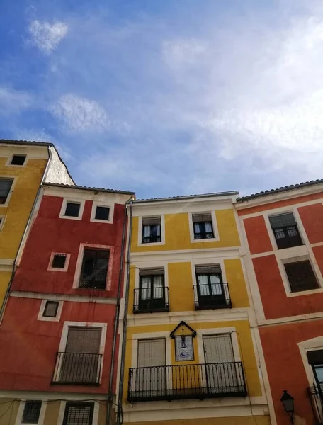 Vertical Low Angle Shot Orange Yellow Buildings Cuenca Spain Blue — Stock Photo, Image