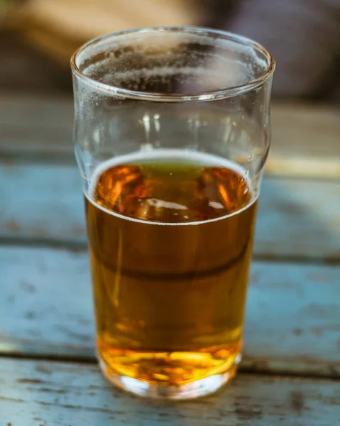 木製の表面にビールのガラスの垂直閉鎖ショット — ストック写真