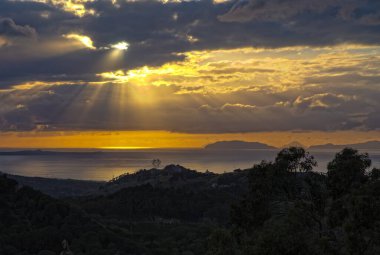 Spring sunset from Peloritani Mountains looking towards Gesso town; small volcanic arc of  Aeolian Islands on horizon. Tyrthenian Sea, Sicily, Italy clipart