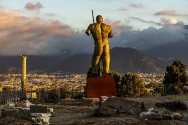 The statue of Daedalus looking at Pompeii ruins in Campania, Italy clipart