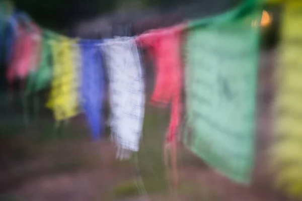 stock image A blurred picture of various colorful prayer flags hanging on the rope