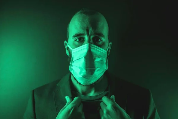 Young Man Wearing Medical Face Mask Green Light Him Concept — Stock fotografie