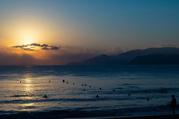 A silhouette of a person standing near the beach in Nha Trang