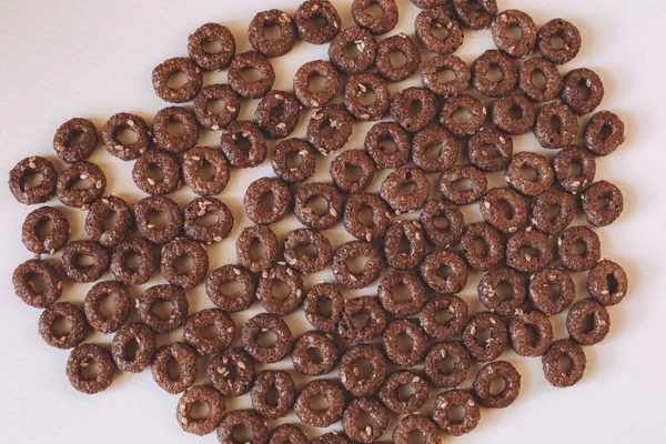 Overhead Closeup Shot Pile Ring Shaped Chocolate Cereal White Surface — Stock Photo, Image