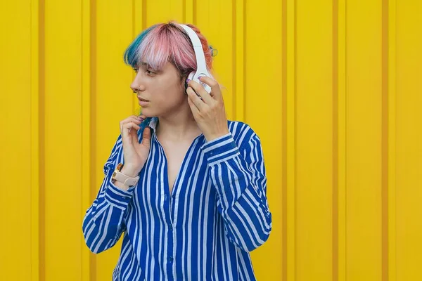 Cheerful Young Female Blue Striped Shirt Headphones Standing Front Yellow — Stock Photo, Image