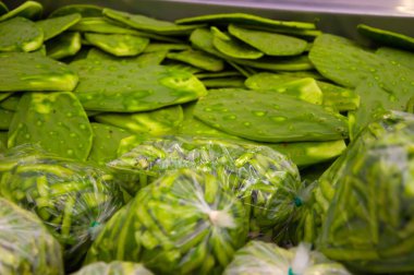 Cleaned and packaged nopales for sale in market clipart