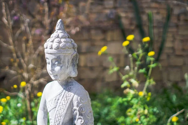 Hermoso Plano Estatua Piedra Buda Jardín Con Flores Amarillas Fondo —  Fotos de Stock