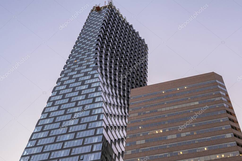 A low angle shot of Telus Sky tower captured under the blue sky in Calgary, Alberta, Canada