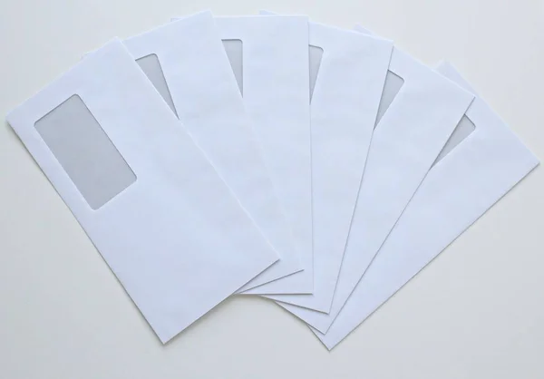 Işıkların Altında Beyaz Bir Masanın Üzerindeki Zarfların Yüksek Açılı Görüntüsü — Stok fotoğraf