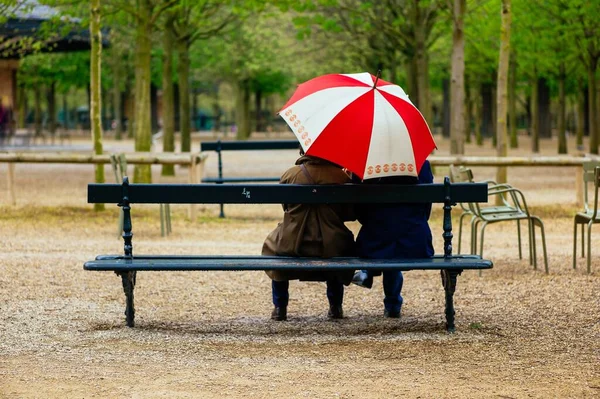 Двоє Людей Сидять Під Тими Парасольками Парку — стокове фото