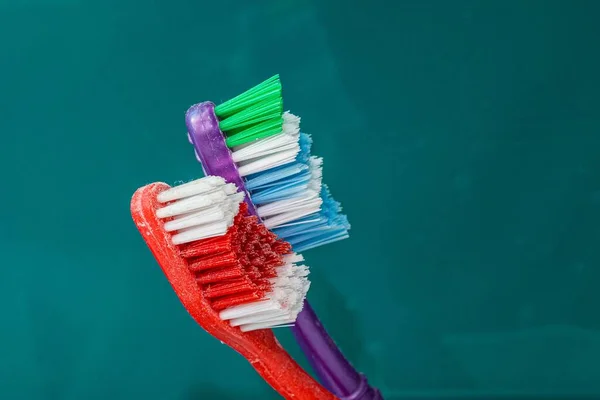Closeup Two Colorful Toothbrushes Lights Green Blurry Background — Stock Photo, Image