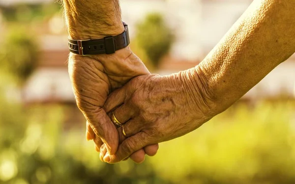 Primer Plano Una Pareja Ancianos Tomados Mano Bajo Luz Del — Foto de Stock