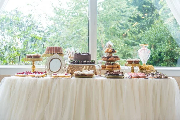 Νόστιμα Κέικ Cupcakes Και Γλυκά Ένα Τραπέζι Κοντά Ένα Μεγάλο — Φωτογραφία Αρχείου