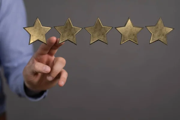 rating concept with hand of star on screen