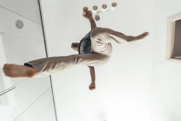 Low Angle Shot Male Jumping His Living Room Ceiling — Stockfoto