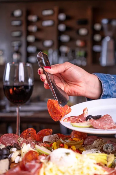 Person Putting Variety Meat Assortment Plate Glass Wine — Stock Photo, Image