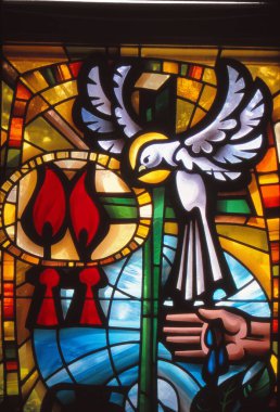 LOS ANGELES, UNITED STATES - May 07, 1985: Stained Glass window of Roman Catholic sacraments of Baptism and Confirmation with Holy Spirit as dove. clipart