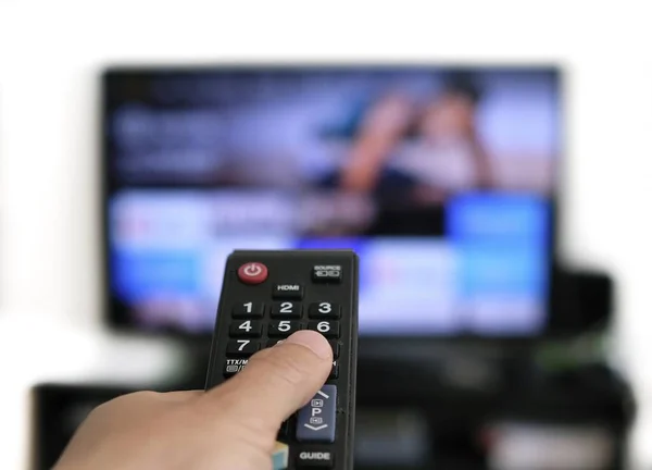 Hand Holding Remote Control Screen Background Binge Watching Favourite Show — Stock Photo, Image