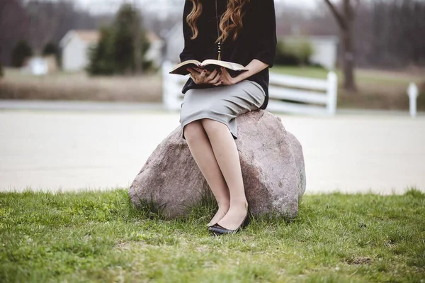 View Female Wearing Grey Skirt Reading Book While Sitting Rock — Stock Photo, Image