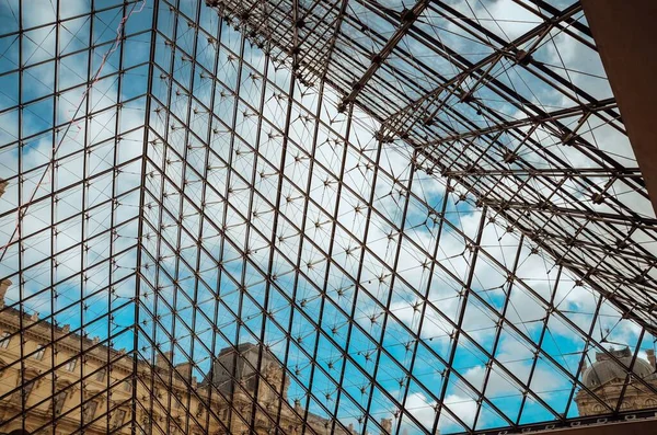 A low angle shot of the beautiful glass ceiling of the Louvre museum captured in Paris, France
