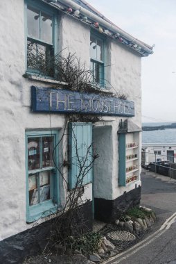 MOUSEHOLE, CORNWALL, UNITED KINGDOM - Mar 03, 2019: The Mousehole restaurant and cafe, shop in Mousehole, Cornwall clipart
