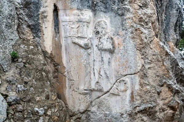 Old Hittite carvings on stone wall among the ruins at Yazilikaya rock shrine in Alacahoyuk, Turkey